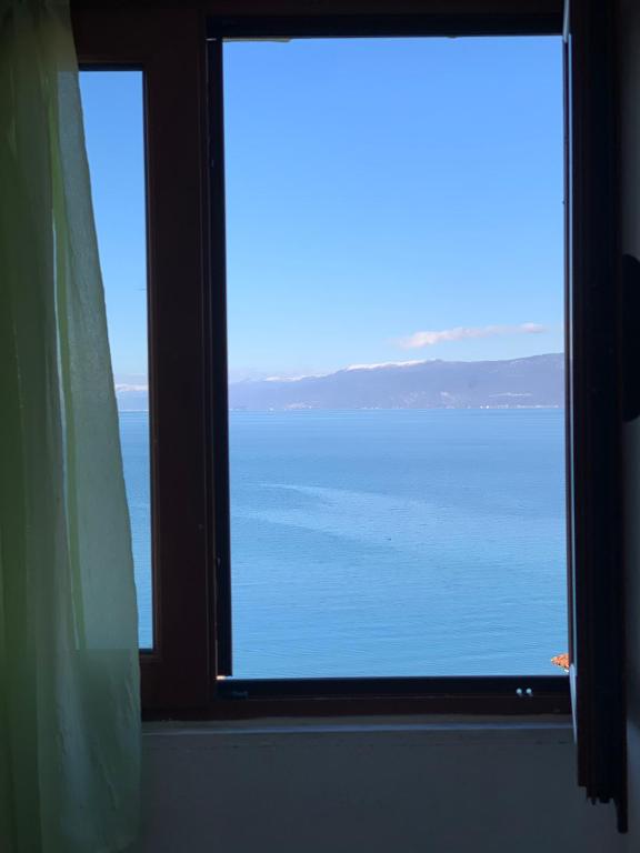 a view of the ocean from a window at Syzo Rooftop 360° in Pogradec