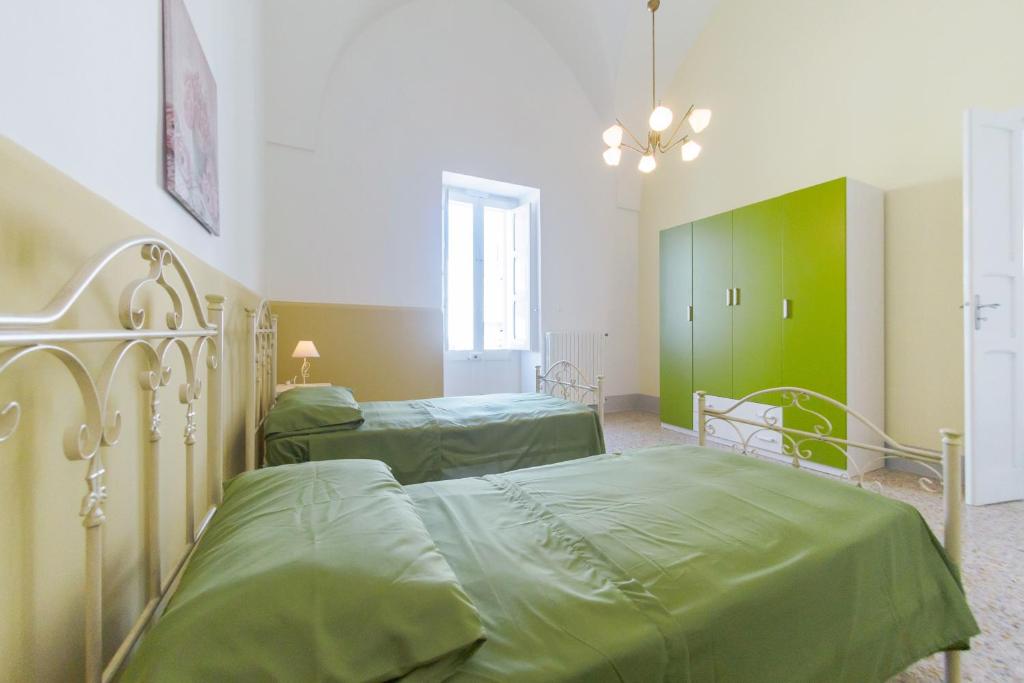 Łóżko lub łóżka w pokoju w obiekcie Casa Vacanze Penelope
