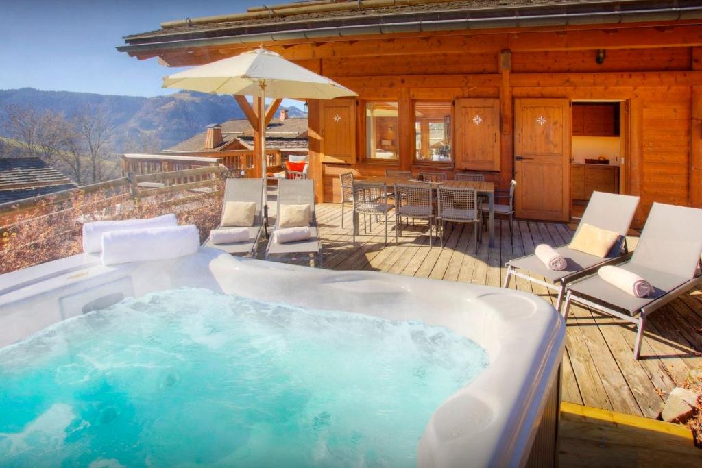 a hot tub on the deck of a cabin at Chalet Alpachic - OVO Network in La Clusaz