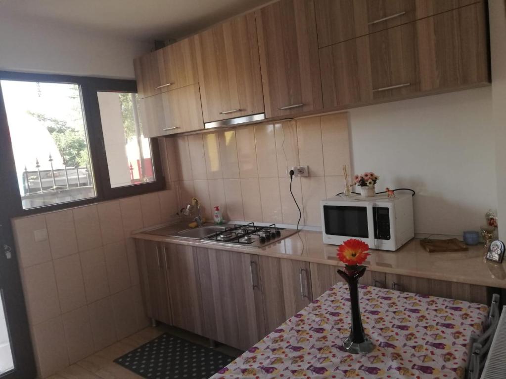 a small kitchen with a table with a vase on it at Casa Ana in Eforie Sud