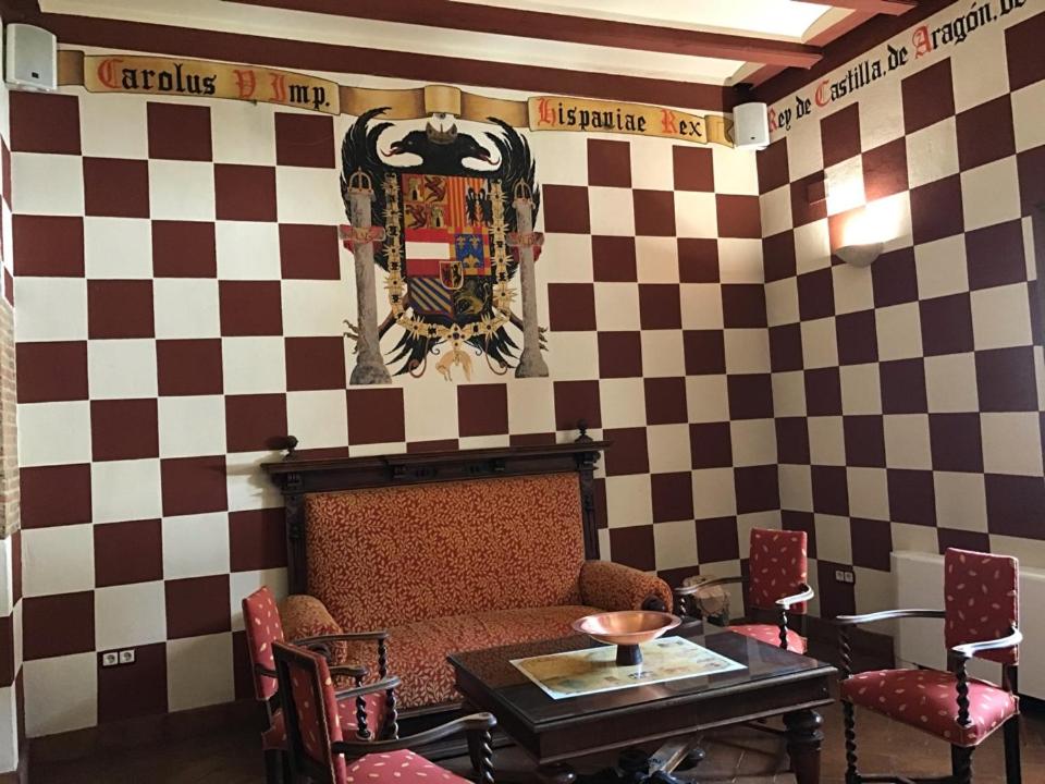 a living room with a couch and a table at Hotel Rural Abadía de Yuste in Cuacos de Yuste