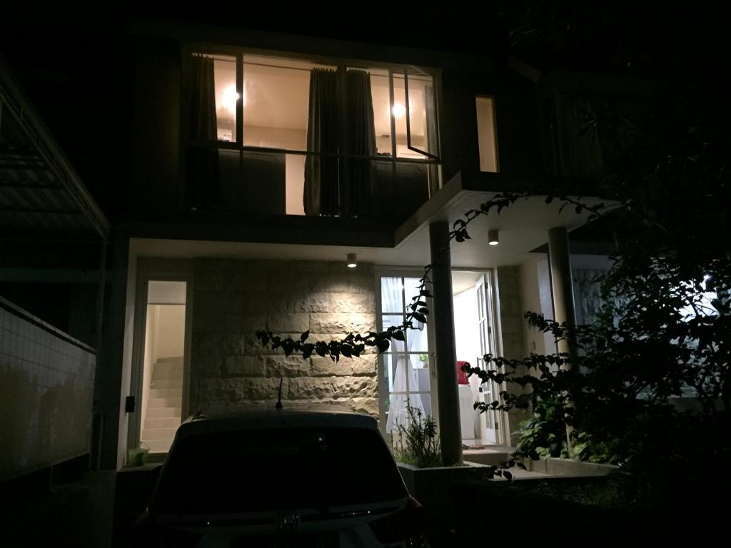 a night time view of a house with a balcony at House at Taman Dayu in Pasuruan