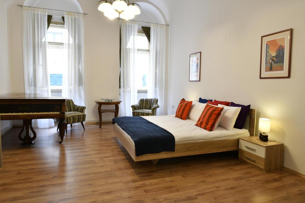 a bedroom with a bed and a piano at Apartment George&Dragon in Zagreb