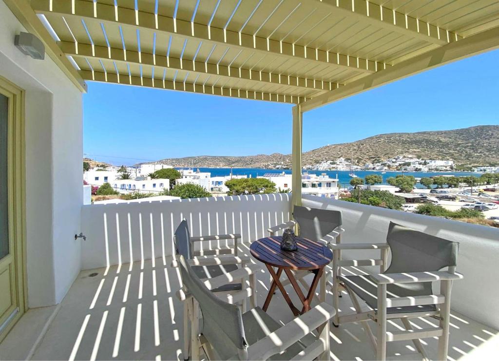 a patio with a table and chairs on a balcony at Diasino Apartments and Car Rental in Katapola