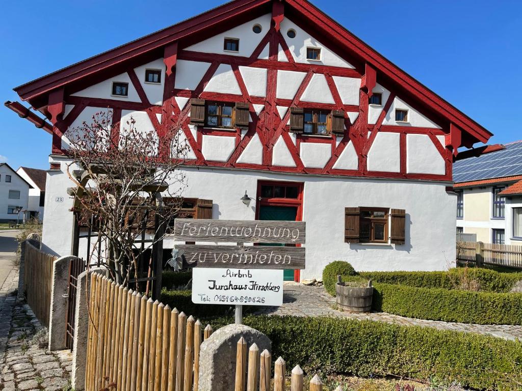 a house with a sign in front of it at Jurahaus Hirschberg EG Wohnung in Beilngries