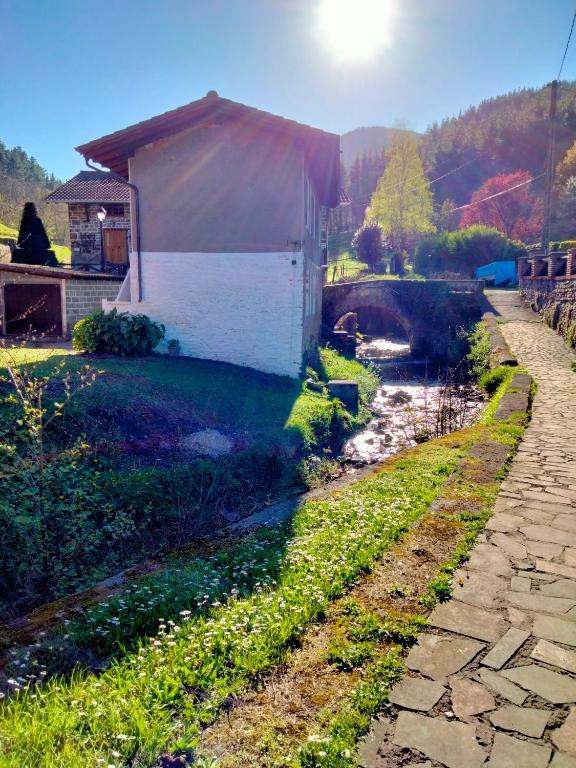 a building on the side of a river at Errekaondo in Areatza