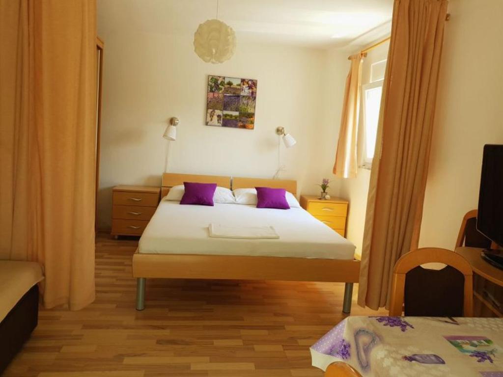 Postel nebo postele na pokoji v ubytování Apartments Andelic