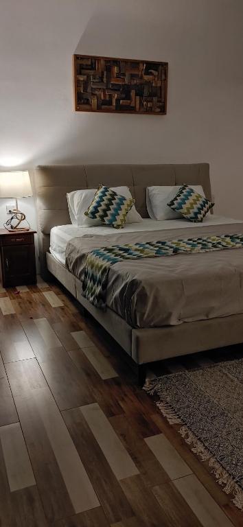 a bedroom with two beds and a wooden floor at Labrize Studio in La Gaulette