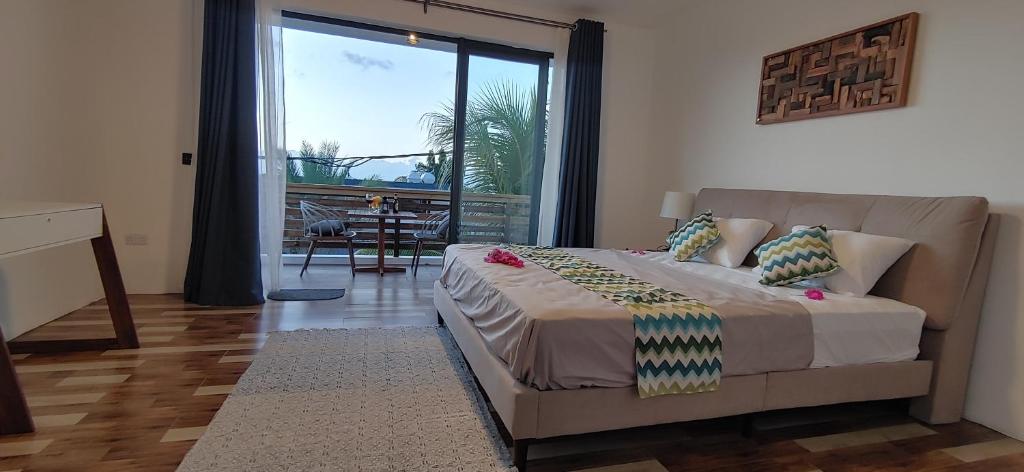 a bedroom with a bed and a sliding glass door at Labrize Studio in La Gaulette