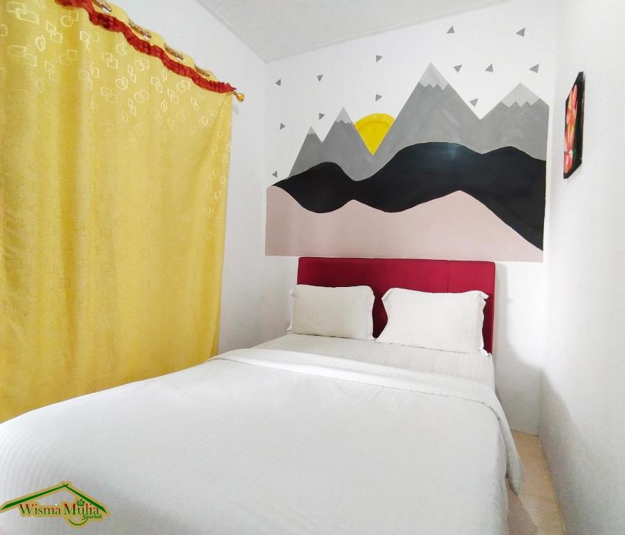 a bedroom with a bed with a red headboard at Wisma Mulia Syariah Bandar Lampung in Hajimana