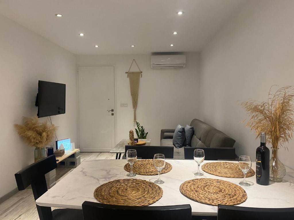 a living room with a table with wine glasses on it at Luxury Lavender in Larnaca