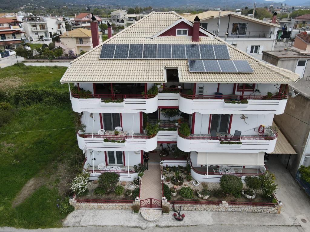 an aerial view of a house with solar panels on the roof at Elenas Apartments in Plataria