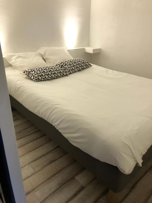 a bed with a leopard print blanket on it at Chez Mel et Manu in Sanary-sur-Mer