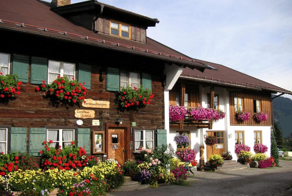 a building with flowers in front of it at Landhaus Schmid in Oberstdorf