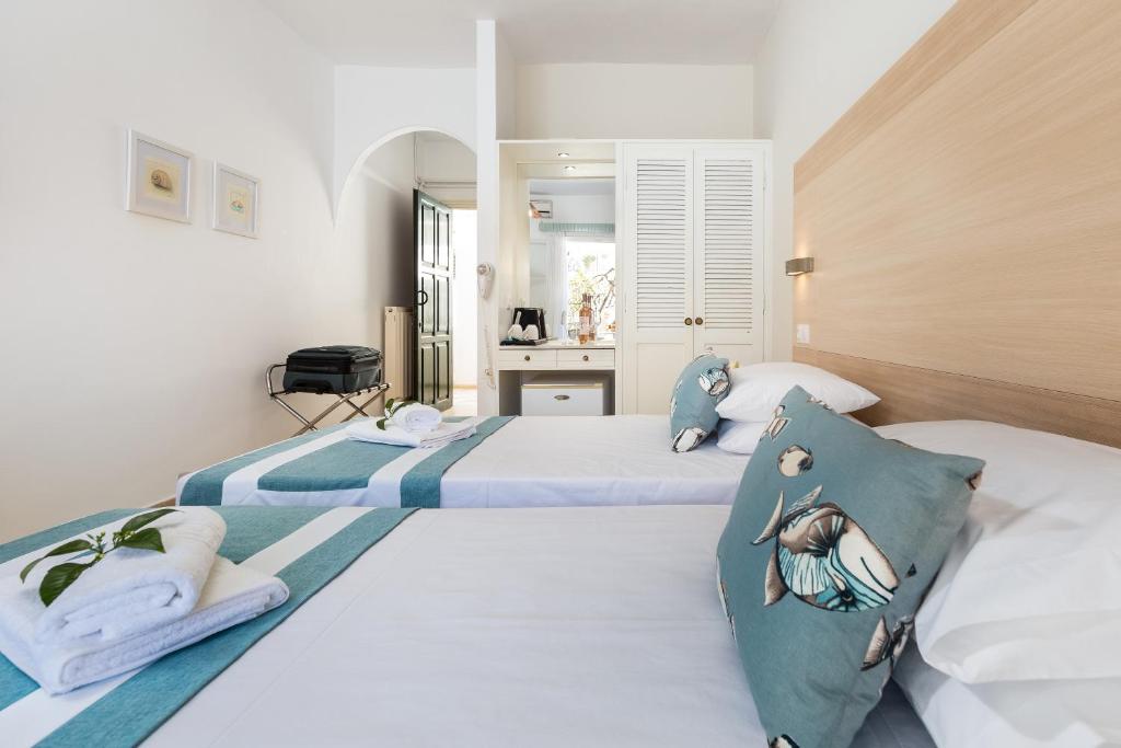 A bed or beds in a room at Iliada Beach Hotel