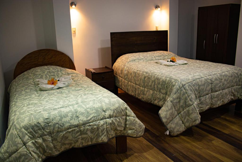 A bed or beds in a room at Hotel Los Laureles