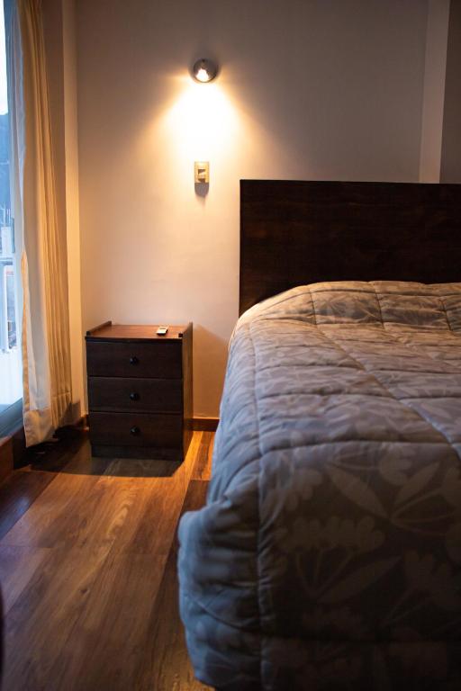A bed or beds in a room at Hotel Los Laureles