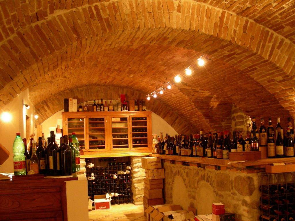 a room filled with lots of bottles of wine at Bed&Wine in Brisighella