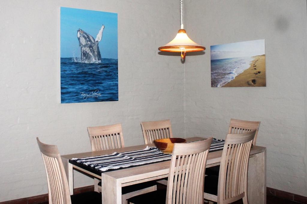 a dining room with a table and four chairs at Dolphin View Self Catering in Scottburgh
