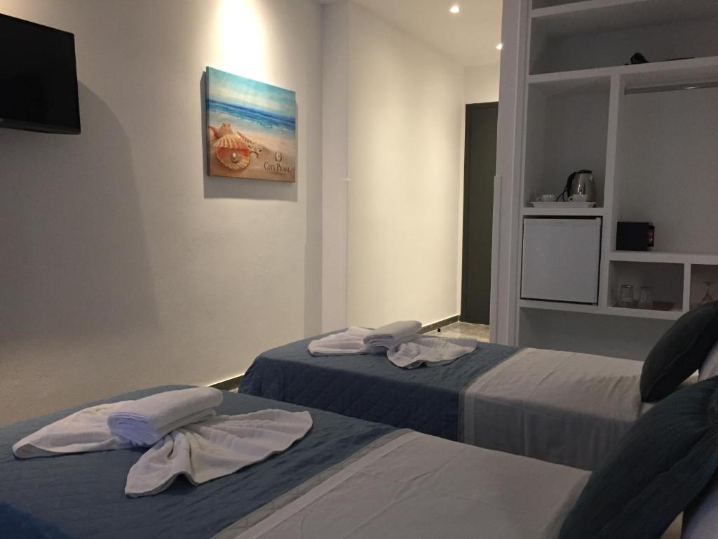 Ліжко або ліжка в номері City Pearl Hotel