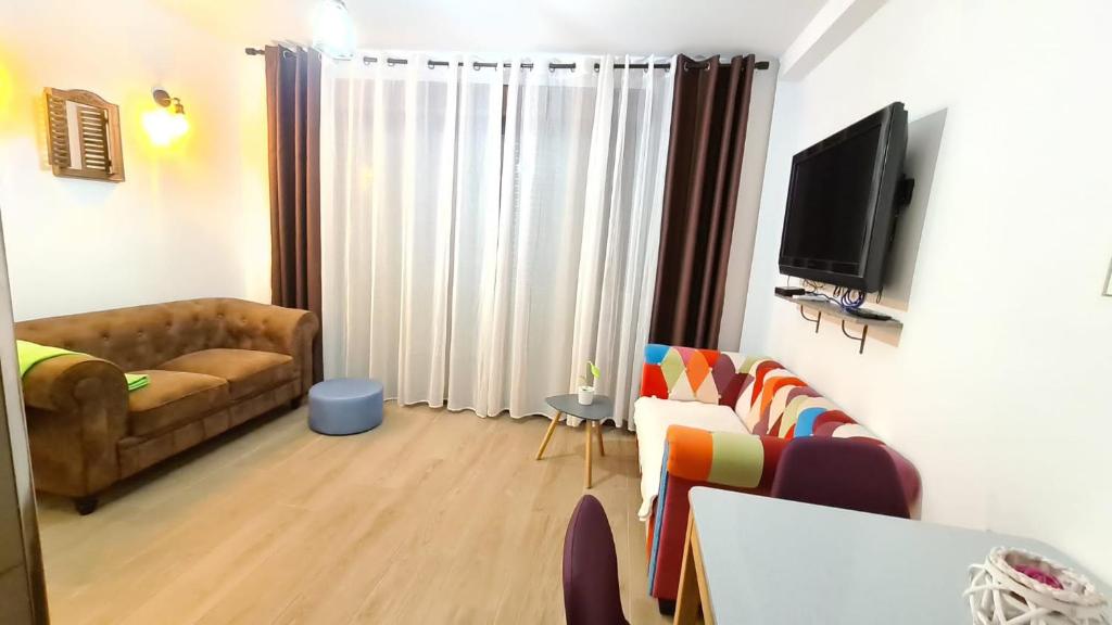 salon z kanapą i telewizorem w obiekcie Sunny Seaside Escape in Aguadulce w mieście Aguadulce