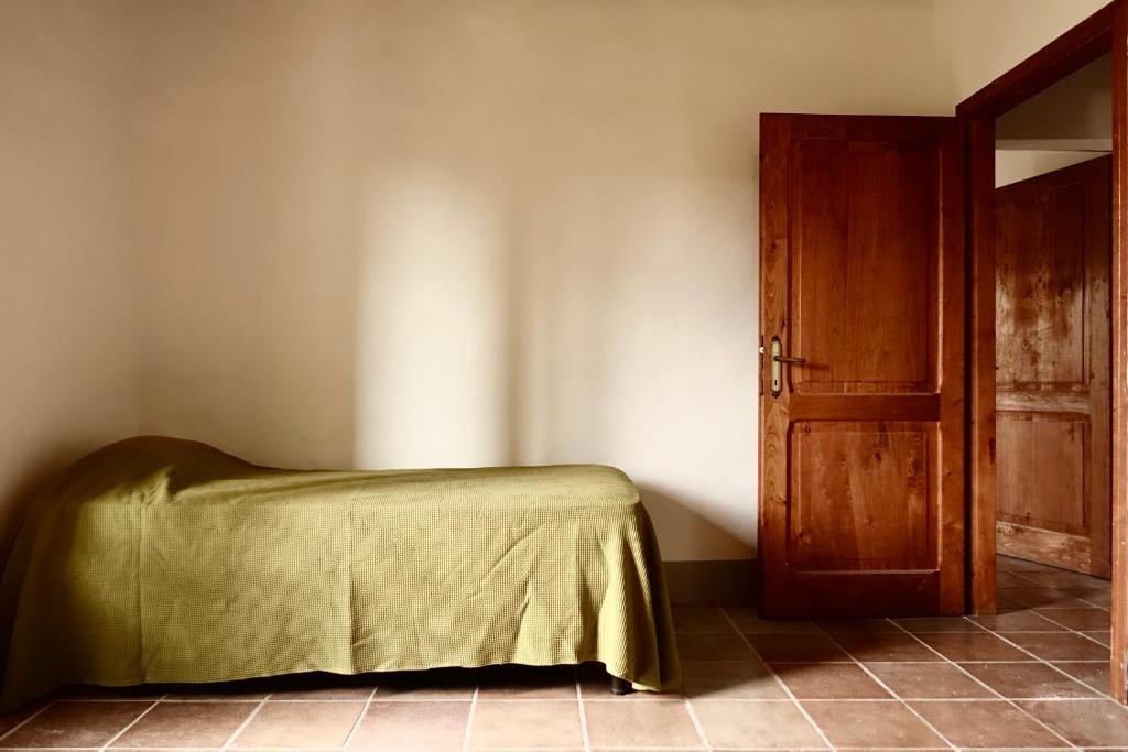 Łóżko lub łóżka w pokoju w obiekcie Casa alla Vecchia Posta di Bagno Vignoni
