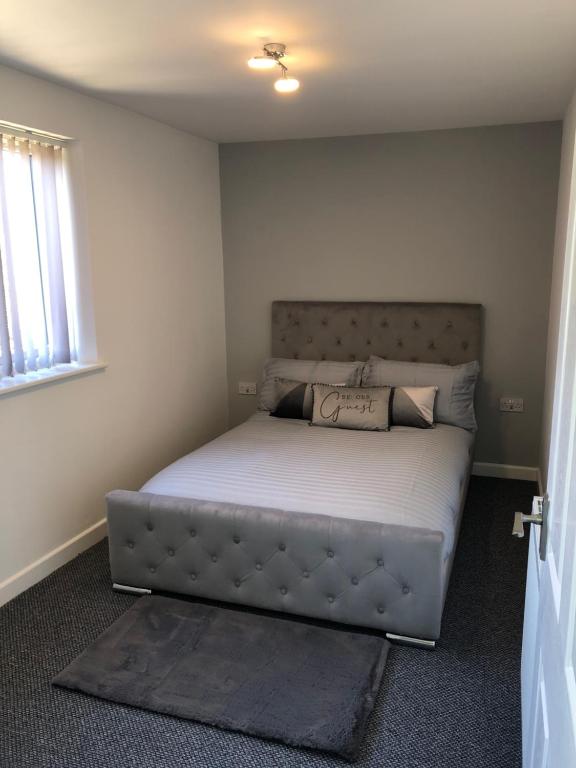 a bedroom with a bed in a room at Driftwood Apartment - Skegness in Skegness
