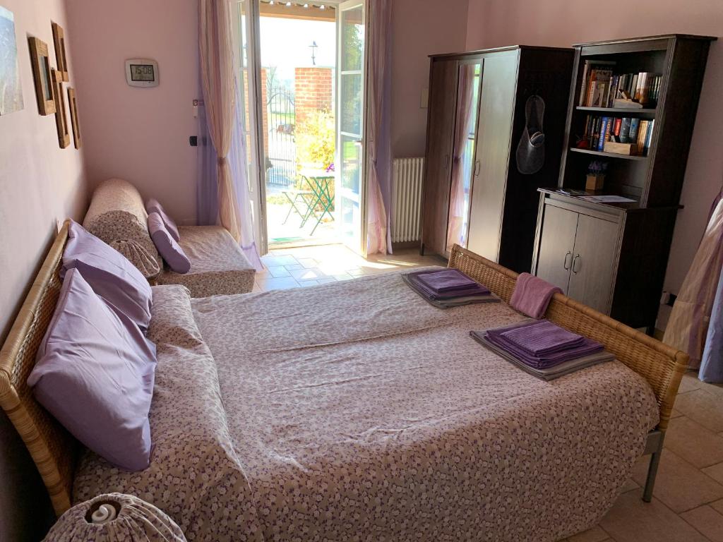 Postel nebo postele na pokoji v ubytování B&B Cascina Martinetta