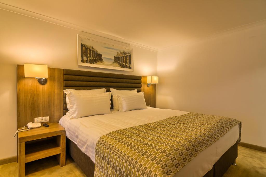 Un pat sau paturi într-o cameră la Hotel Saturn