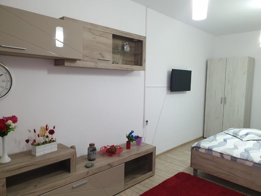 a bedroom with a bed and a tv on a wall at Casa Cinema in Braşov