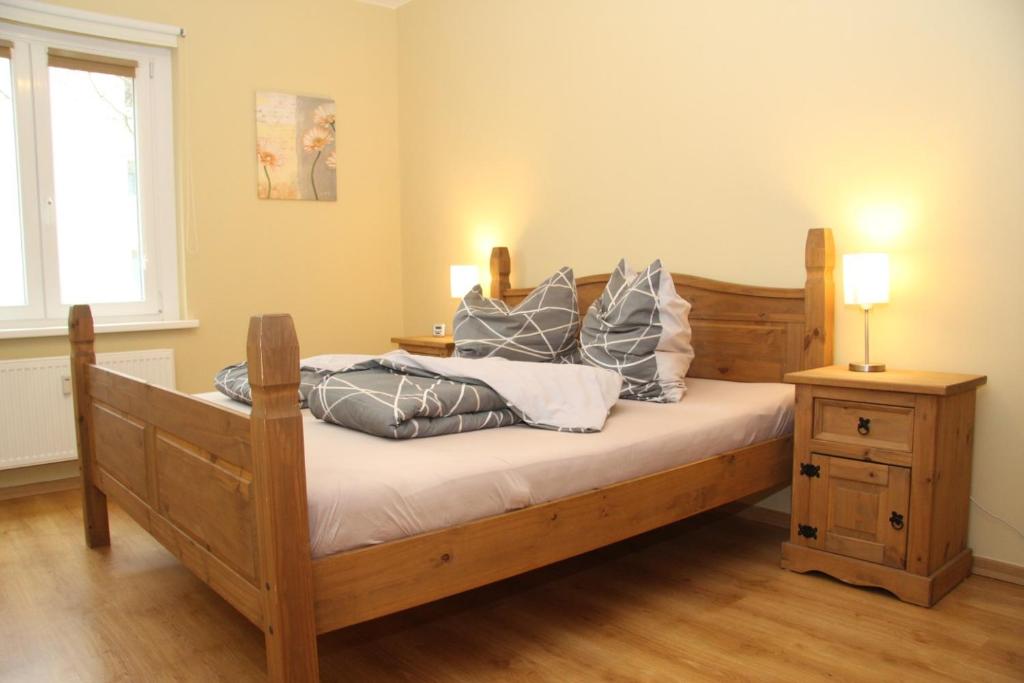 a bedroom with a wooden bed with pillows on it at Apartment Prenzlauer Berg in Berlin