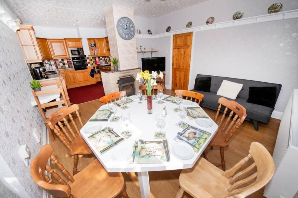 a dining room and living room with a table and chairs at The Bungalow at Seaway's, Sleeps 11 + in Great Driffield