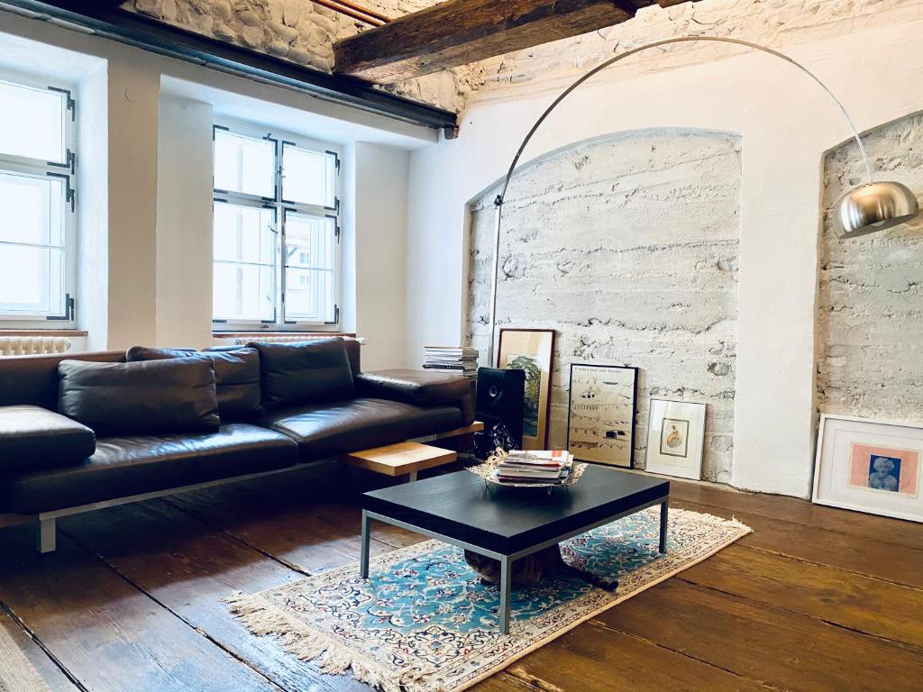 a living room with a leather couch and a coffee table at Casa Livia in Lindau