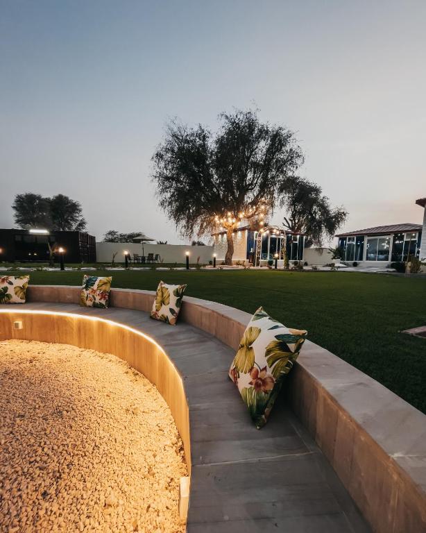 a row of pillows sitting on a bench in a park at Seven Elements Resort in Ras al Khaimah