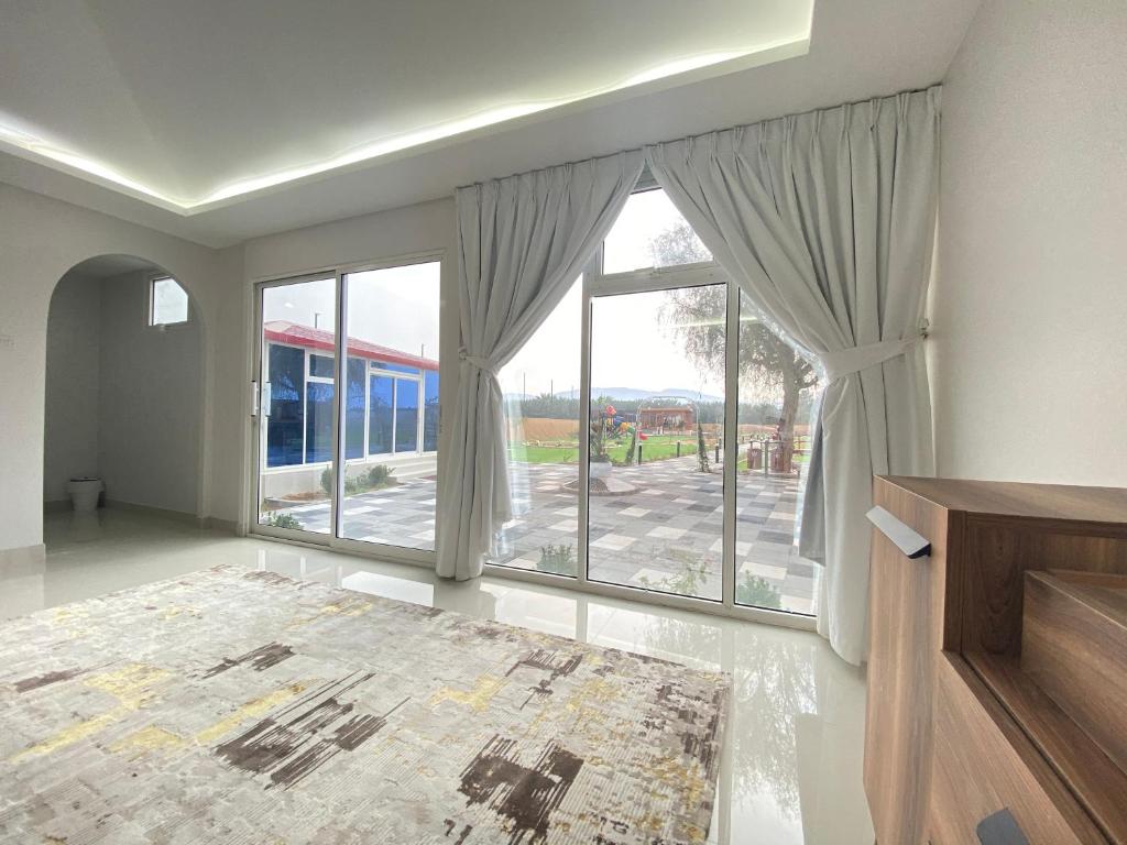 a large living room with a large window with a view at Seven Elements Resort in Ras al Khaimah