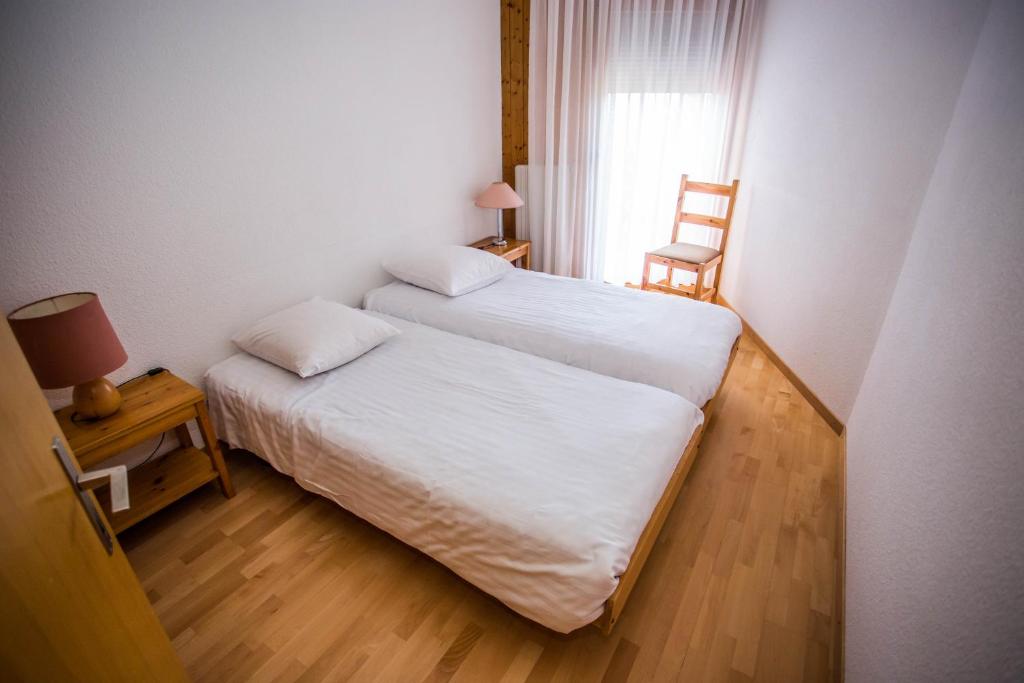 Postel nebo postele na pokoji v ubytování Eden Resort Anzère