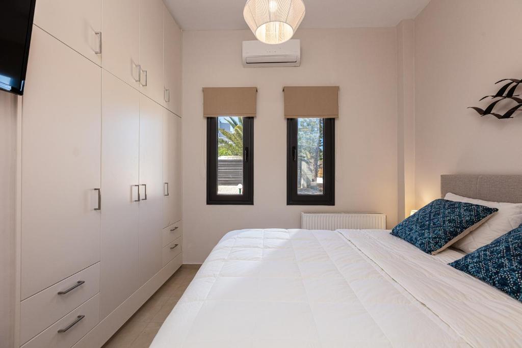 Łóżko lub łóżka w pokoju w obiekcie Artemisia Residence