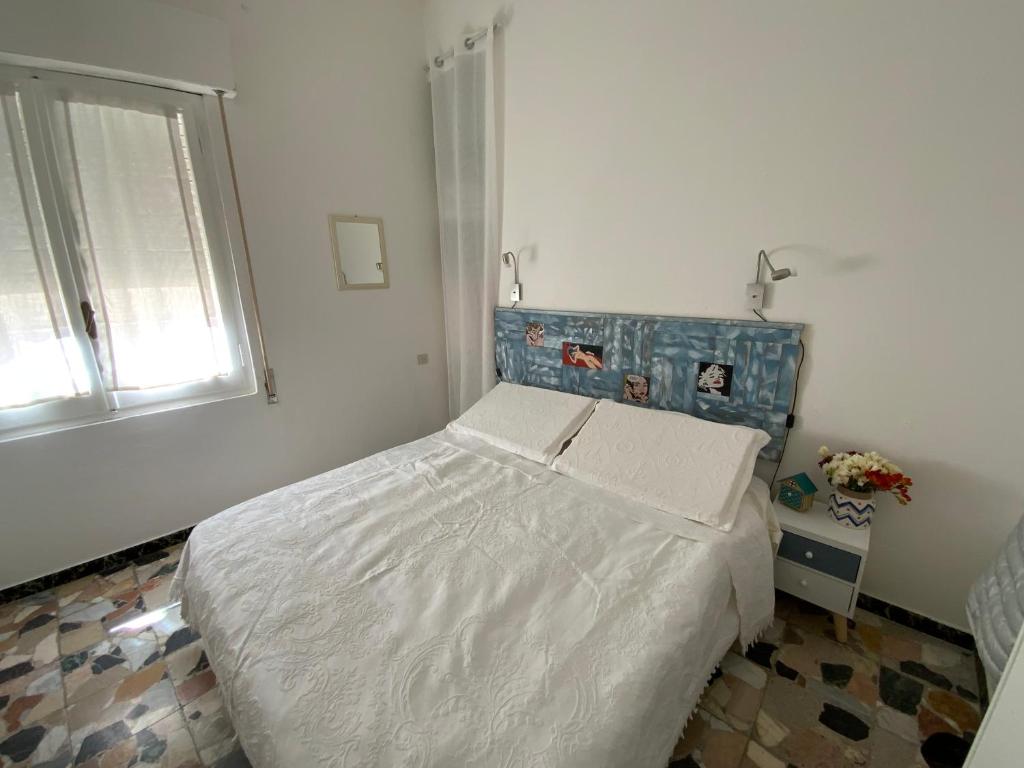 Postel nebo postele na pokoji v ubytování Sa Caletta Appartamenti