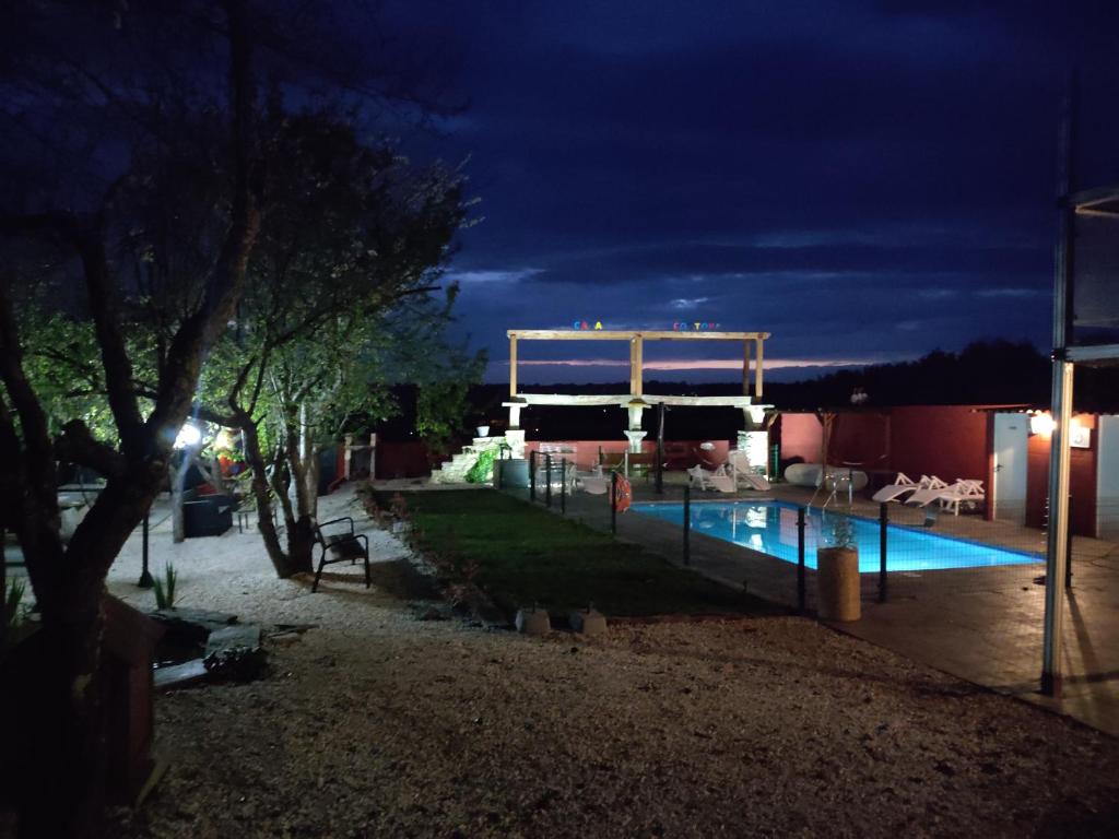 a swimming pool in a yard at night at Casa Costoya in Arzúa