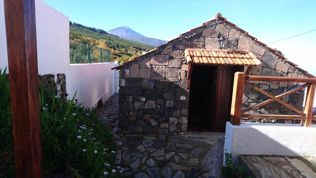 a small stone building with a door on a hill at El pajar de Inés in La Orotava