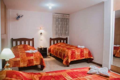 Postel nebo postele na pokoji v ubytování Hotel Amoretto