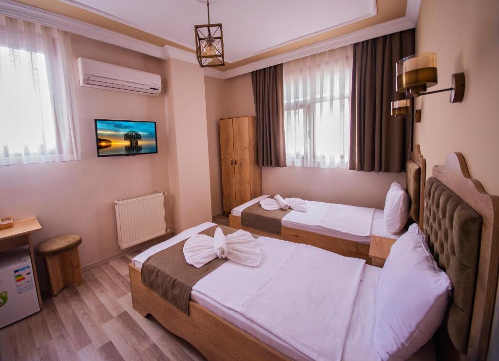 Postel nebo postele na pokoji v ubytování Hotel Orkide