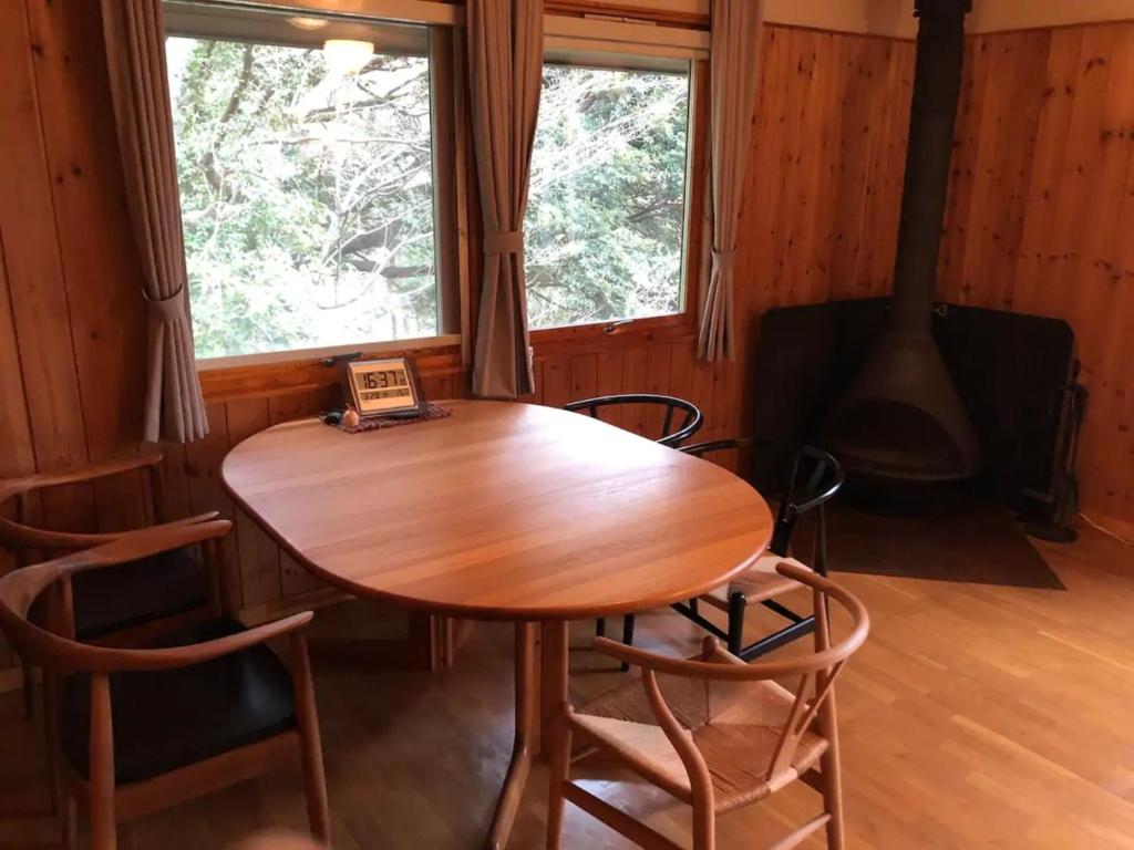 a wooden table and chairs in a room with a fireplace at Trust Maison Atagawa 2 - Vacation STAY 24220v in Okawa