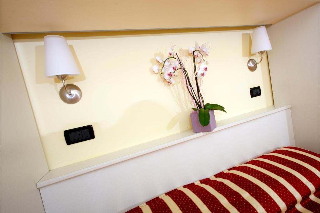 Postel nebo postele na pokoji v ubytování Hotel Baia