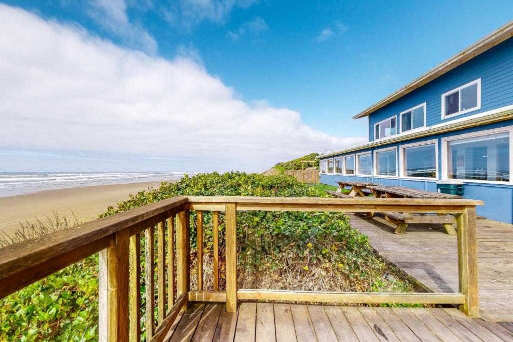 a house on a boardwalk next to the beach at Inn at Sandcastle Beach in Waldport