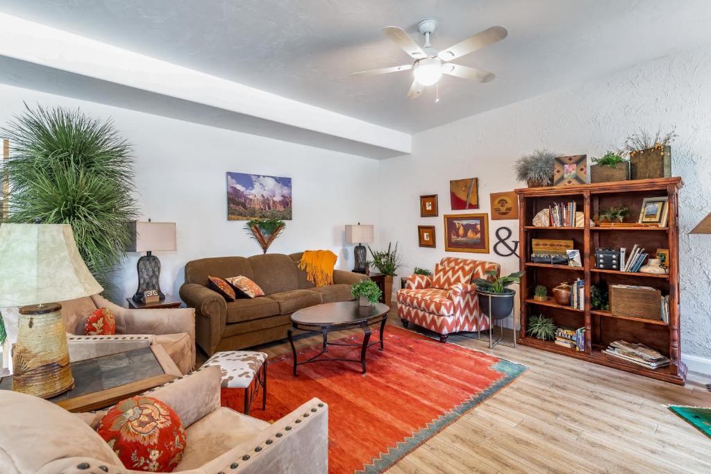 a living room filled with furniture and a ceiling fan at Sunny Cozy Condo in St. George