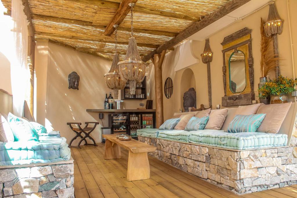 a living room with a couch on a stone wall at Luxury B&B Villa Tauro in Málaga