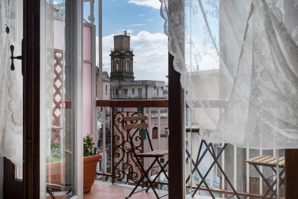 a balcony with a view of a clock tower at Minori Apartment in Minori