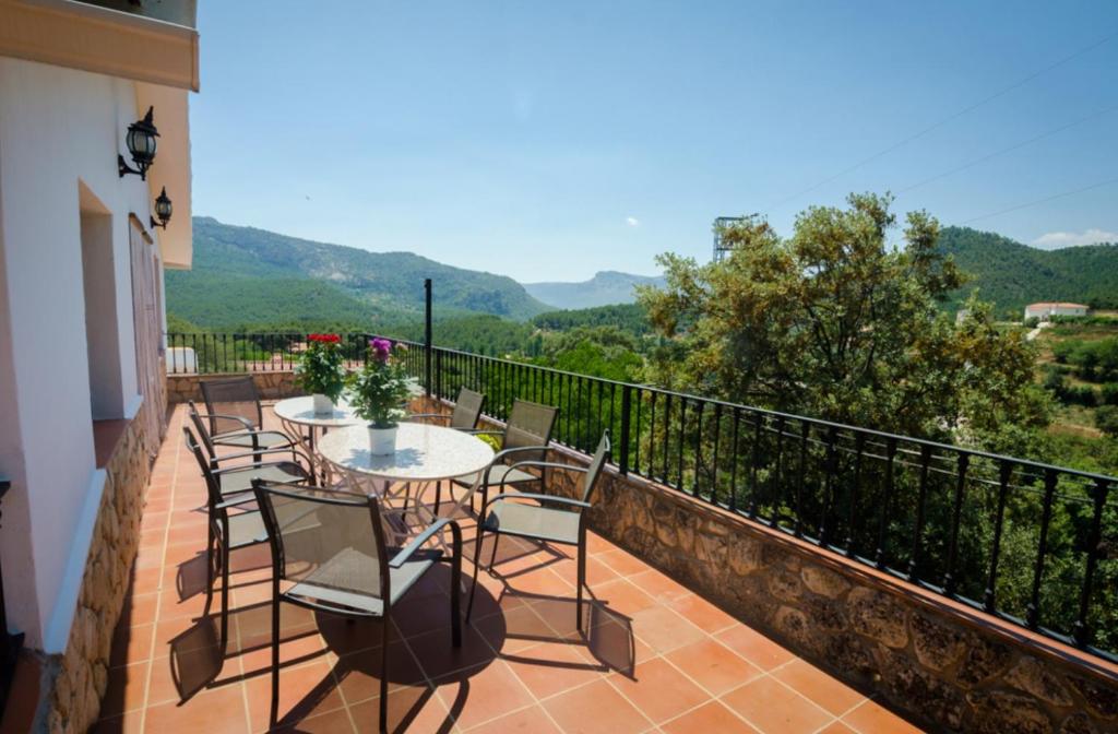 a balcony with tables and chairs and a view at Calar de la Sima in Yeste