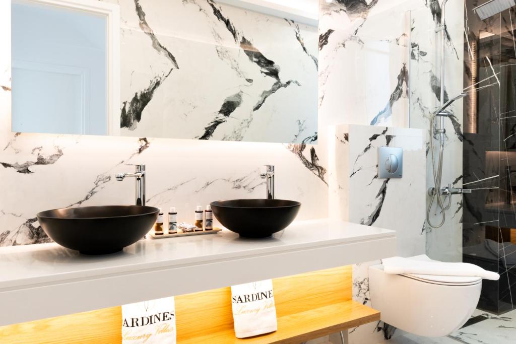 a bathroom with two sinks on a counter at Sardines Luxury Villas in Analipsi